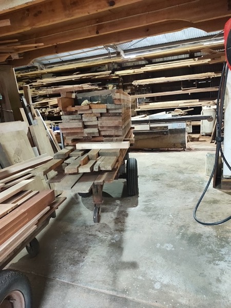 Timber boards racked and stacked on a trolley in the workshop